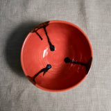 Interior image of a coral handmade wheelthrown chili bowl from the 5th Buffalo collection by Leigh Art.