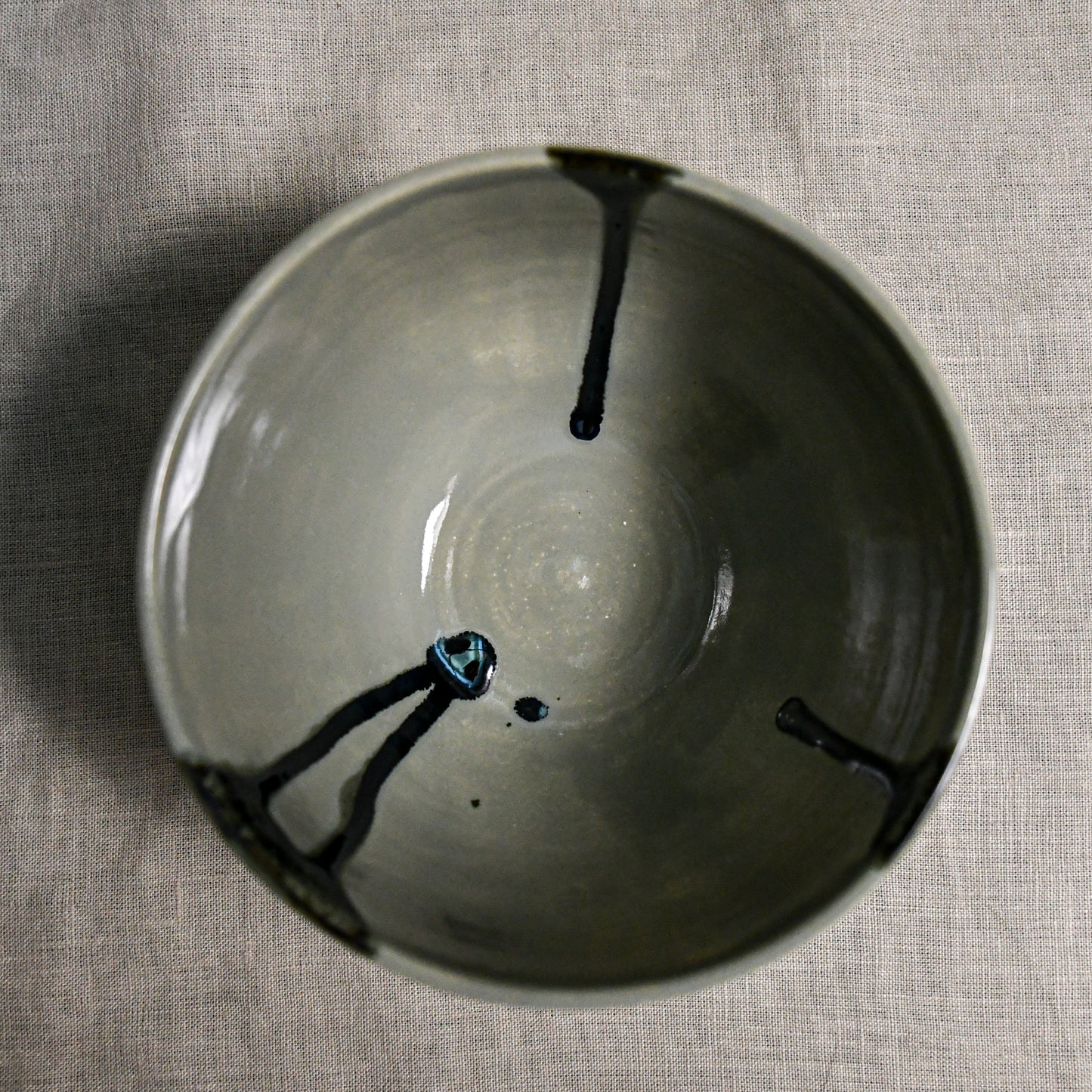 Interior image of a grey handmade wheelthrown chili bowl from the 5th Buffalo collection by Leigh Art.