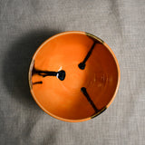 Interior image of an orange handmade wheelthrown chili bowl from the 5th Buffalo collection by Leigh Art.