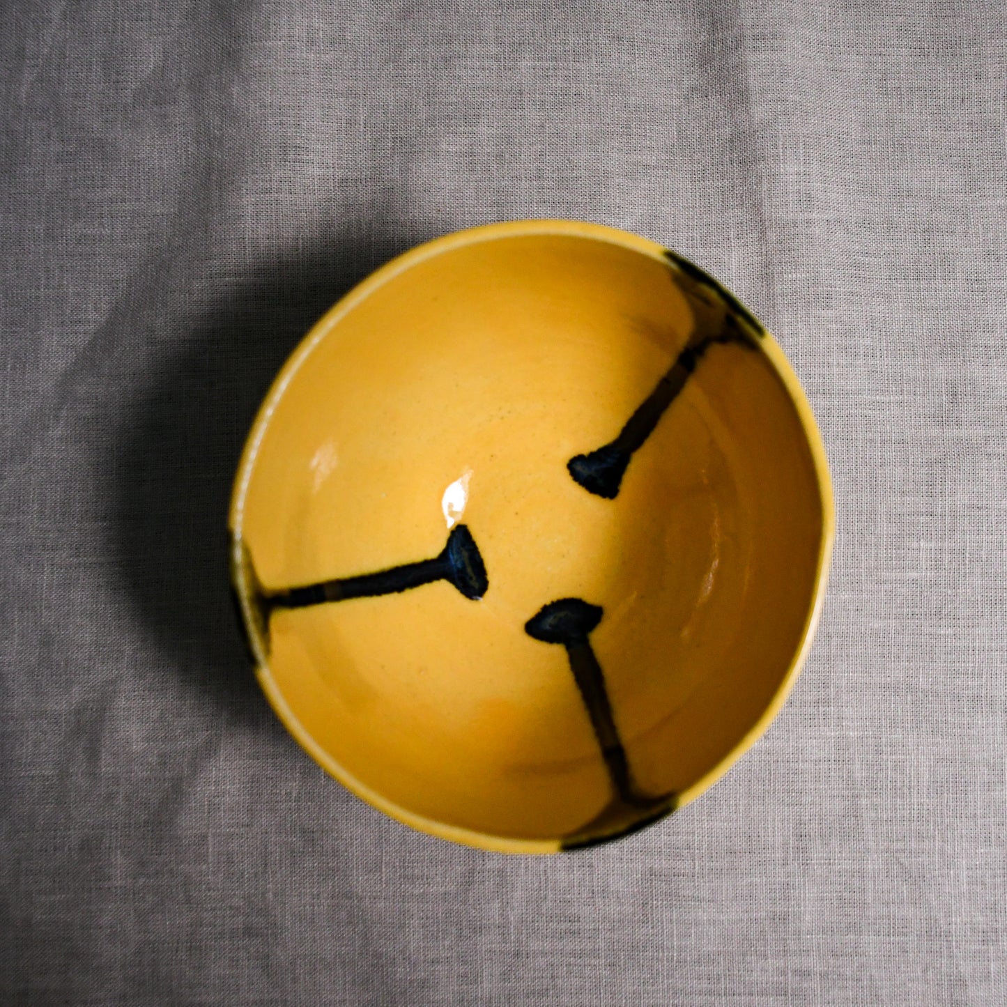 Interior image of a yellow handmade wheelthrown chili bowl from the 5th Buffalo collection by Leigh Art.