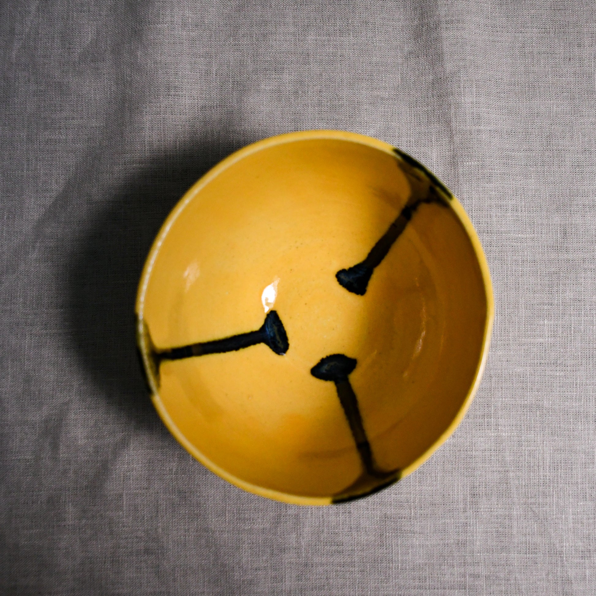 Interior image of a yellow handmade wheelthrown chili bowl from the 5th Buffalo collection by Leigh Art.