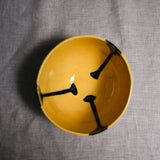 Interior image of a yellow handmade wheelthrown chili bowl from the 5th Buffalo collection by Leigh Art.