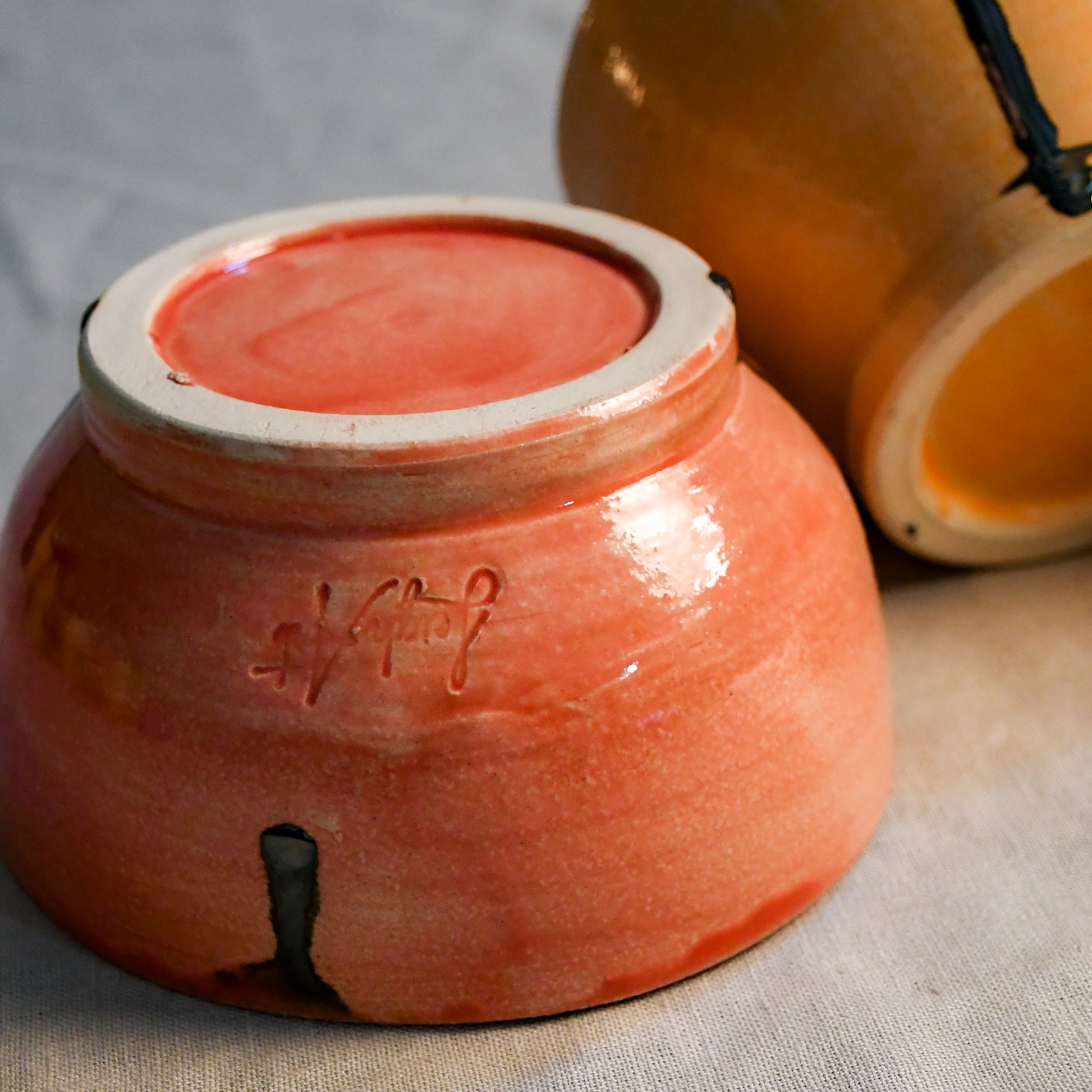 Close up of 5th Buffalo Soft Finish Chili Bowls in coral and jack o lantern.