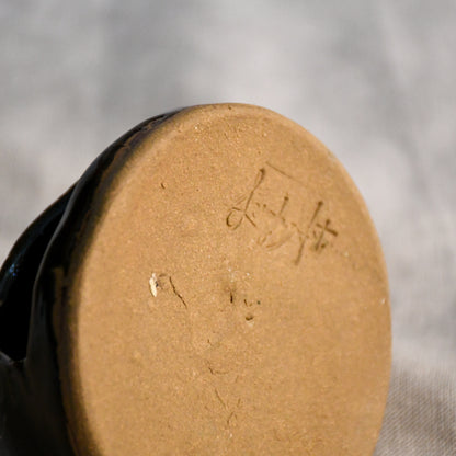 Bottom of a handmade countertop chiminea, wheel thrown, hand-carved, fit for a tea light and glazed in Coffee Bean glaze. 