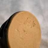 Bottom of a handmade countertop chiminea, wheel thrown, hand-carved, fit for a tea light and glazed in Coffee Bean glaze. 
