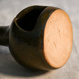 Bottom of a handmade countertop chiminea, wheel thrown, hand-carved, fit for a tea light and glazed in Coffee Bean glaze. 