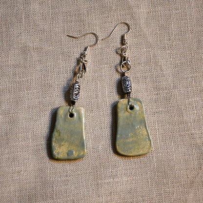 Handmade ceramic dangle earrings by Leigh Art with a modern boho silhouette.