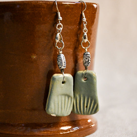 Handmade ceramic dangle earrings by Leigh Art with a modern boho silhouette.
