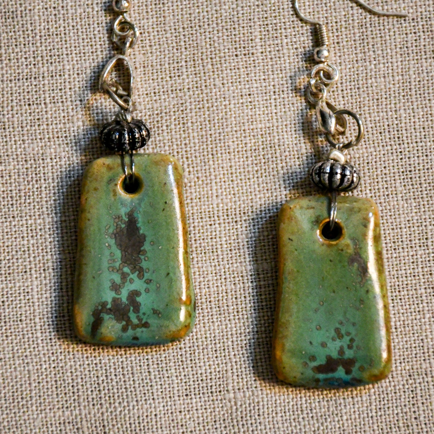 Handmade ceramic dangle earrings by Leigh Art with a modern boho silhouette.