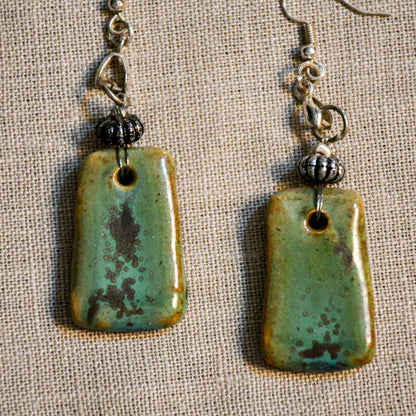Handmade ceramic dangle earrings by Leigh Art with a modern boho silhouette.