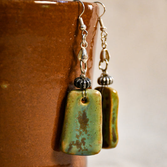 Handmade ceramic dangle earrings by Leigh Art with a modern boho silhouette.