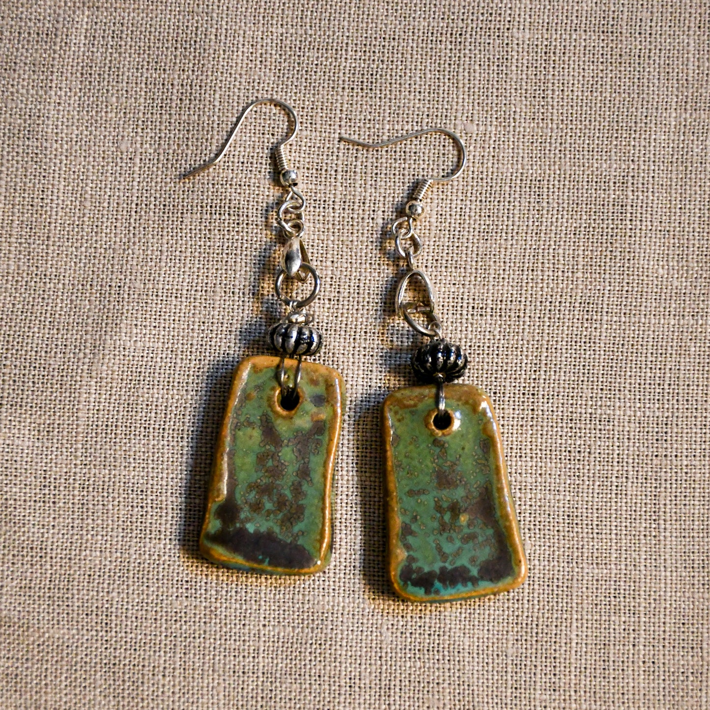 Handmade ceramic dangle earrings by Leigh Art with a modern boho silhouette.