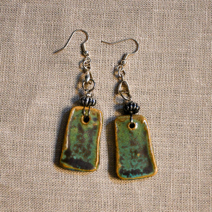 Handmade ceramic dangle earrings by Leigh Art with a modern boho silhouette.