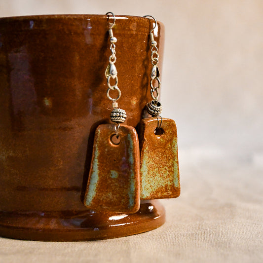 Handmade ceramic dangle earrings by Leigh Art with a modern boho silhouette.