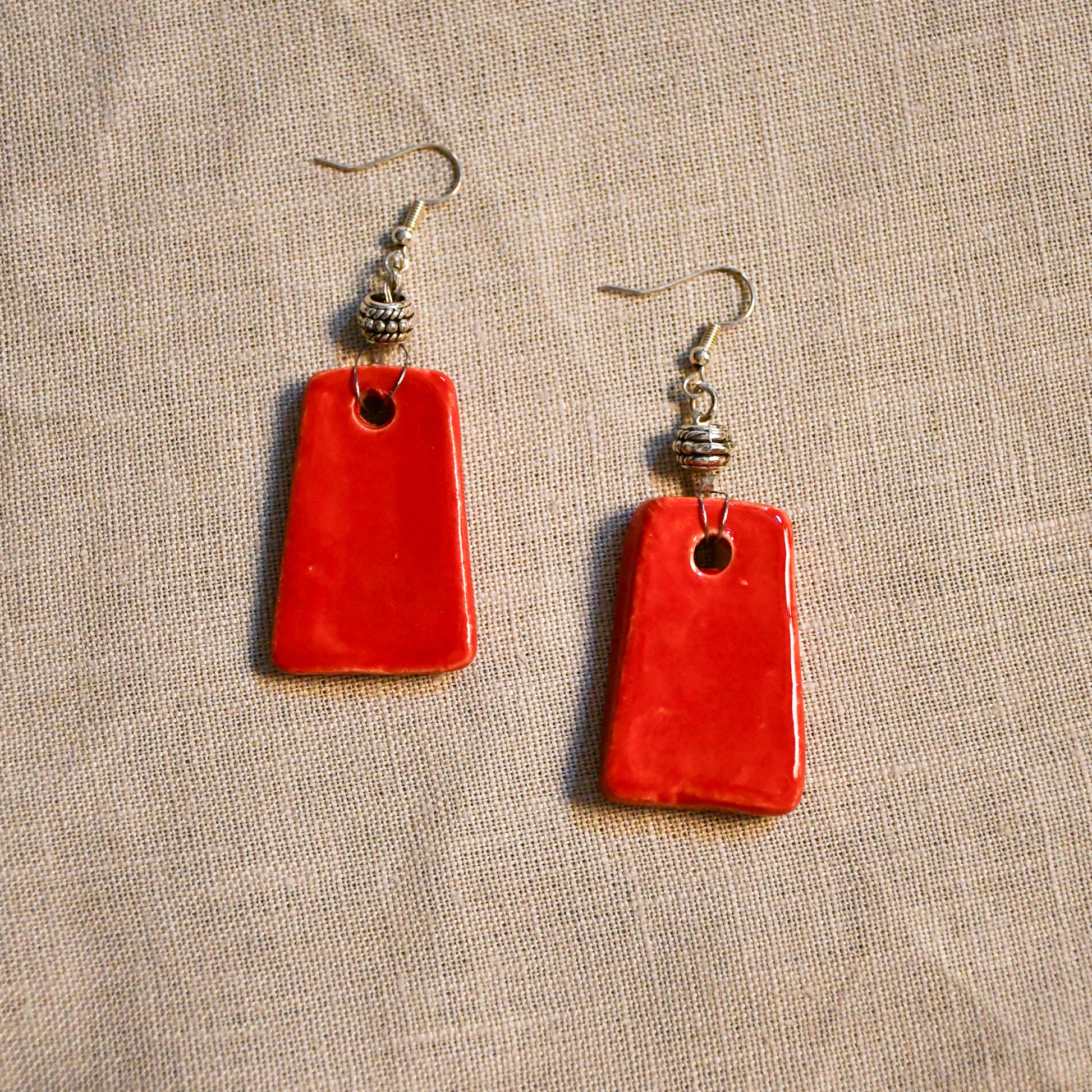 Handmade ceramic dangle earrings by Leigh Art with a modern boho silhouette.