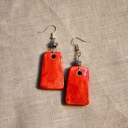 Handmade ceramic dangle earrings by Leigh Art with a modern boho silhouette.