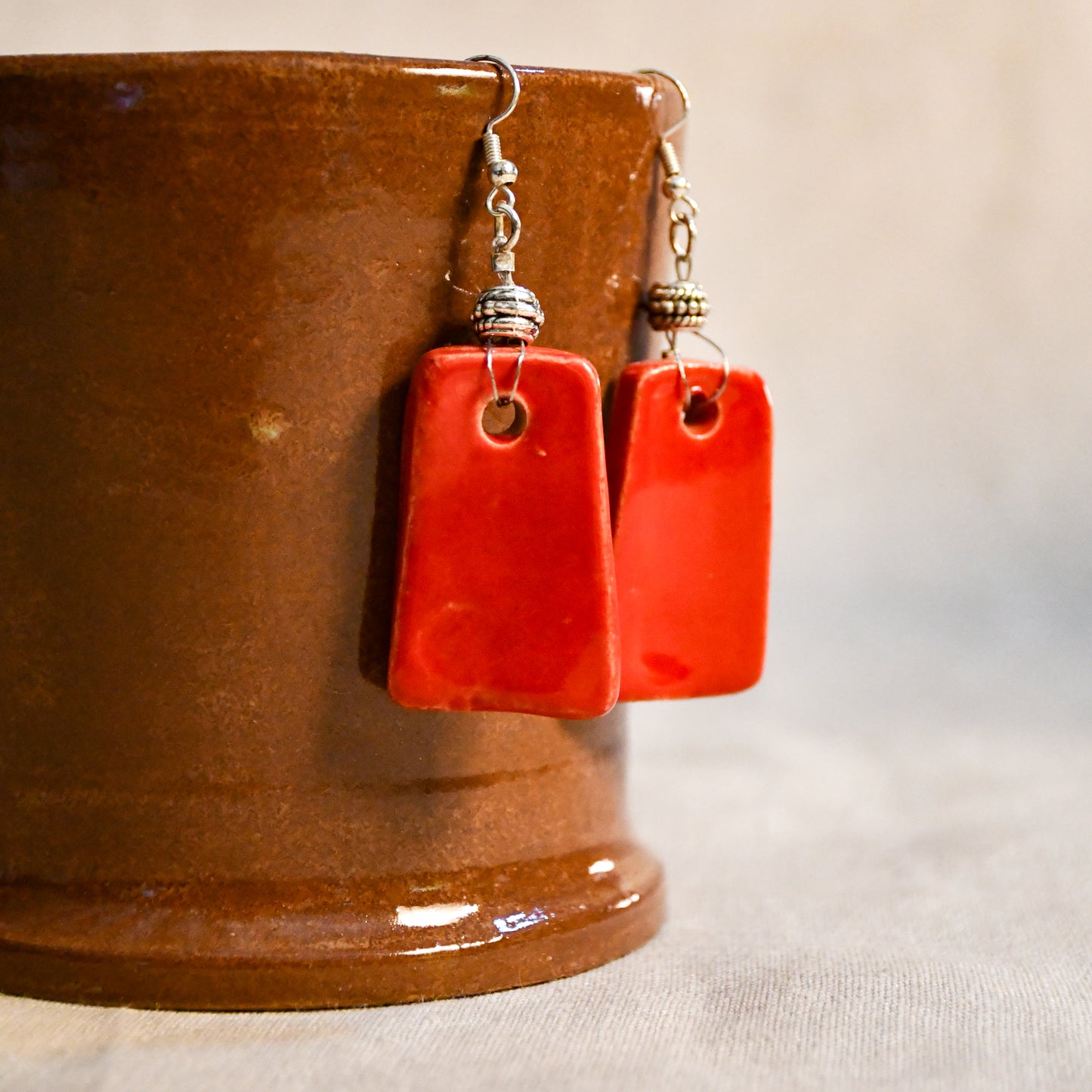 Handmade ceramic dangle earrings by Leigh Art with a modern boho silhouette.