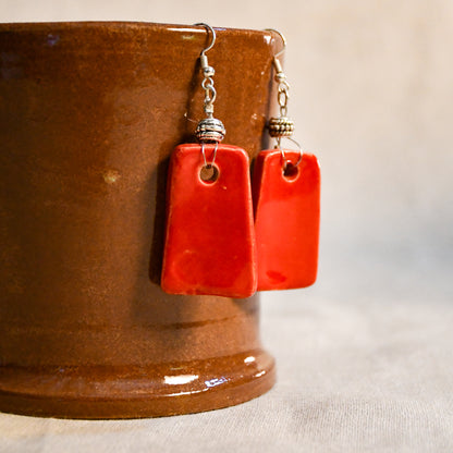 Handmade ceramic dangle earrings by Leigh Art with a modern boho silhouette.