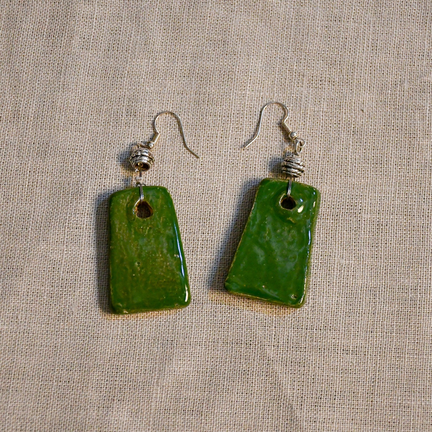 Handmade ceramic dangle earrings by Leigh Art with a modern boho silhouette.