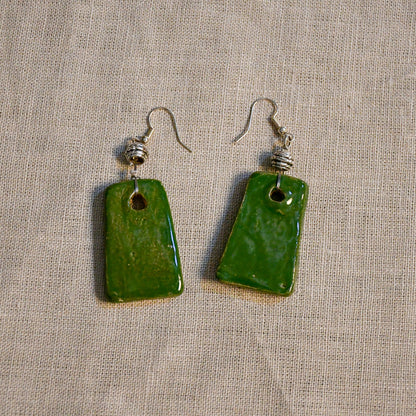 Handmade ceramic dangle earrings by Leigh Art with a modern boho silhouette.