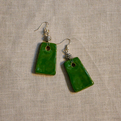 Handmade ceramic dangle earrings by Leigh Art with a modern boho silhouette.