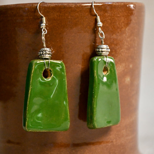 Handmade ceramic dangle earrings by Leigh Art with a modern boho silhouette.