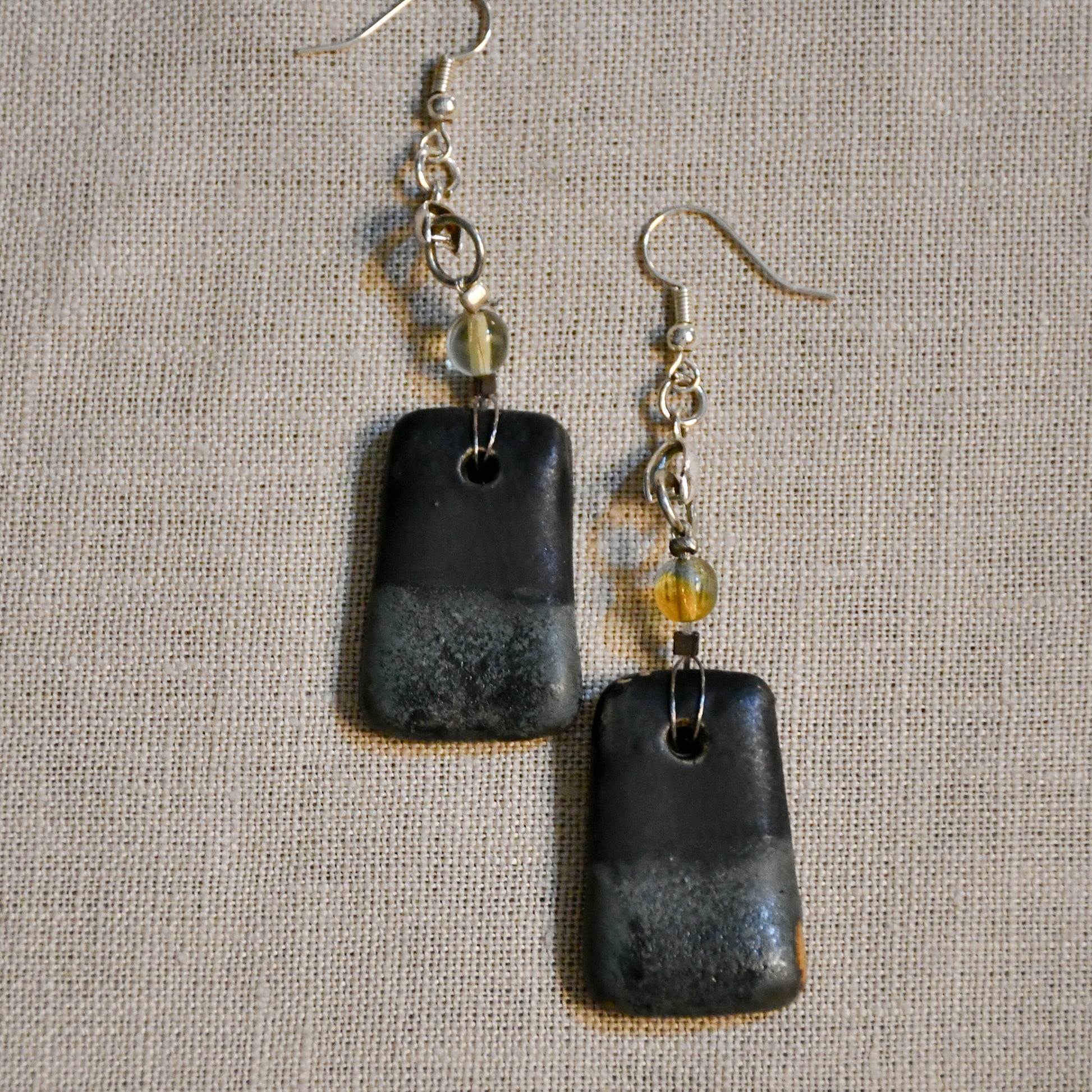 Handmade ceramic dangle earrings by Leigh Art with a modern boho silhouette.