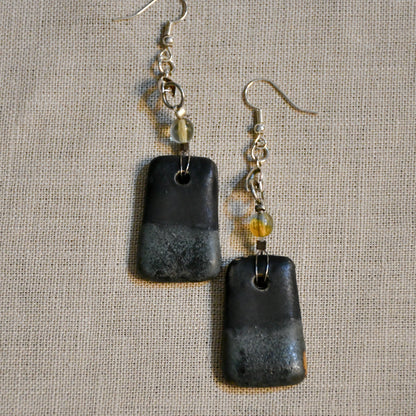 Handmade ceramic dangle earrings by Leigh Art with a modern boho silhouette.