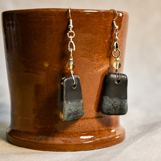 Handmade ceramic dangle earrings by Leigh Art with a modern boho silhouette.