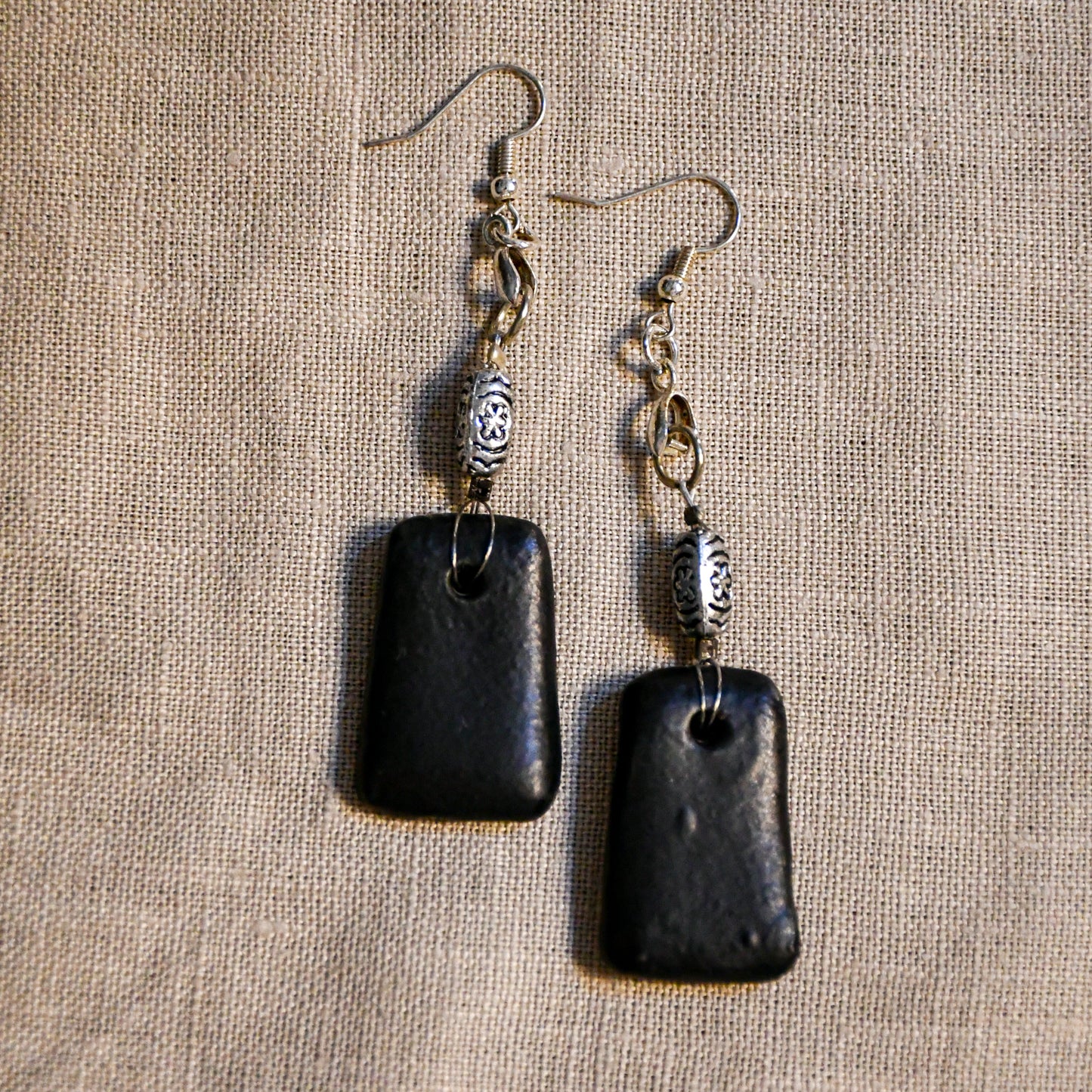 Handmade ceramic dangle earrings by Leigh Art with a modern boho silhouette.