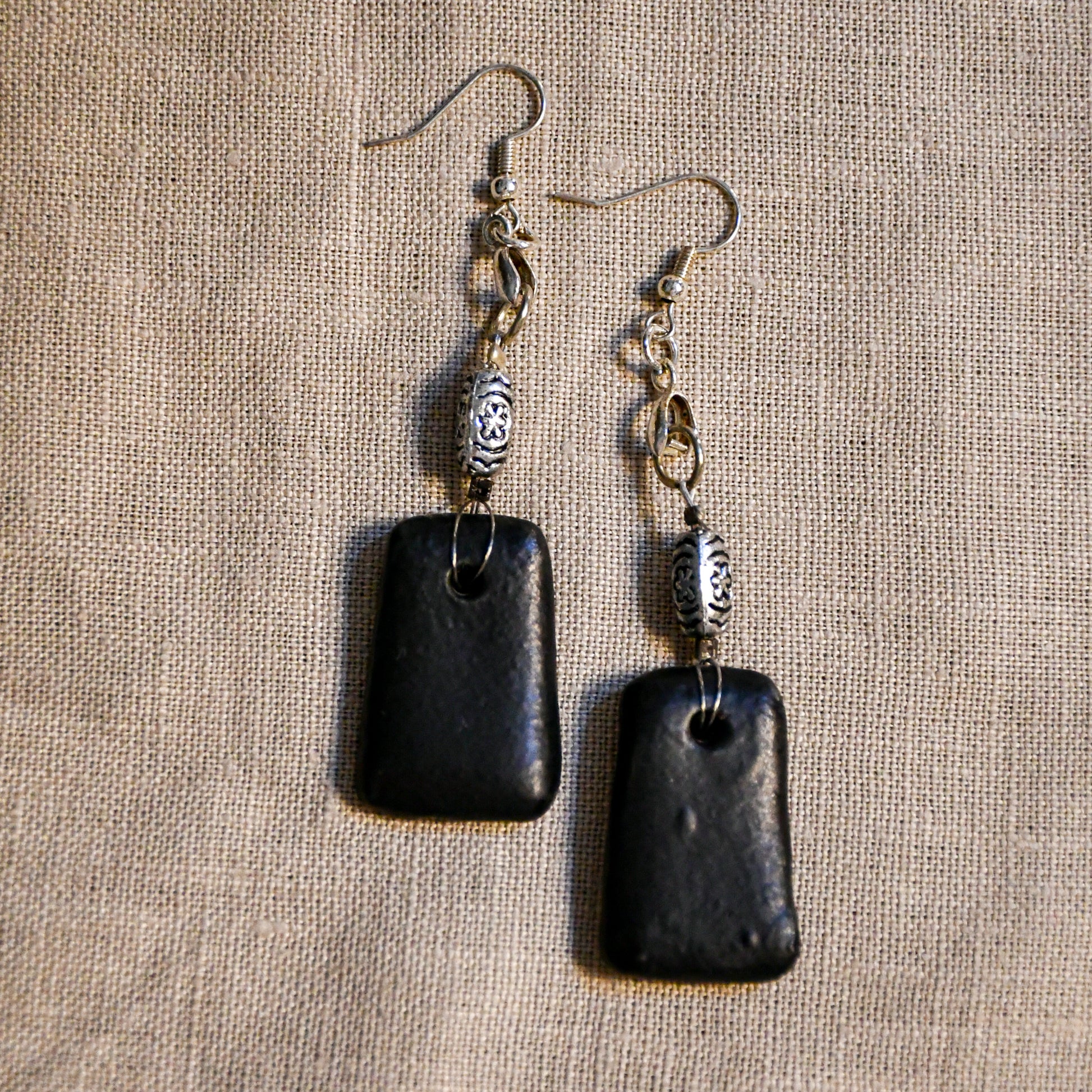 Handmade ceramic dangle earrings by Leigh Art with a modern boho silhouette.