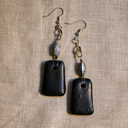 Handmade ceramic dangle earrings by Leigh Art with a modern boho silhouette.