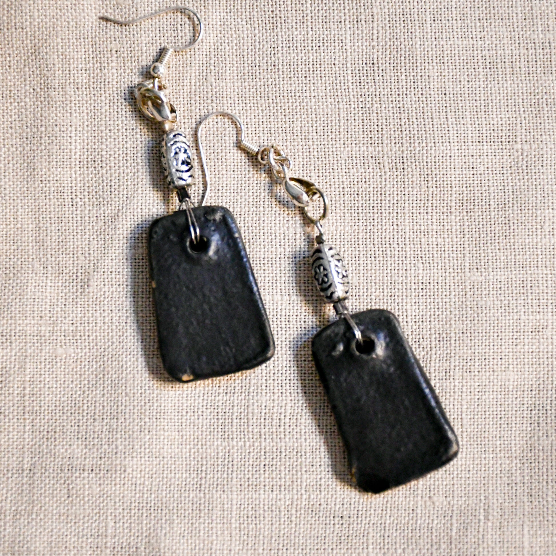 Handmade ceramic dangle earrings by Leigh Art with a modern boho silhouette.