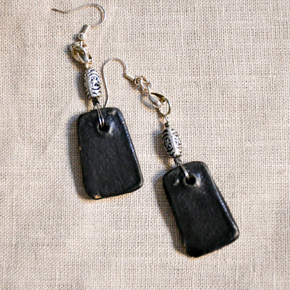 Handmade ceramic dangle earrings by Leigh Art with a modern boho silhouette.