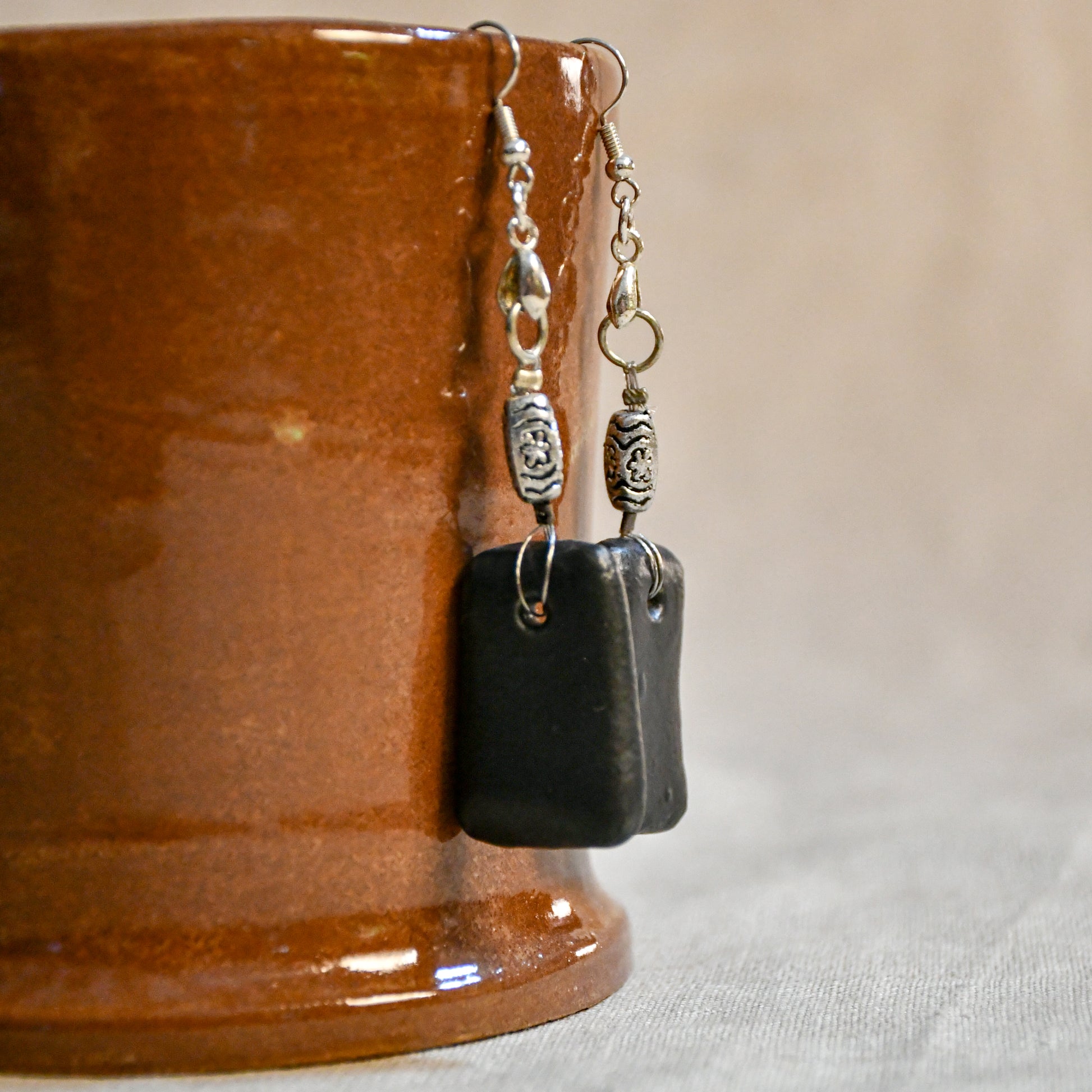 Handmade ceramic dangle earrings by Leigh Art with a modern boho silhouette.