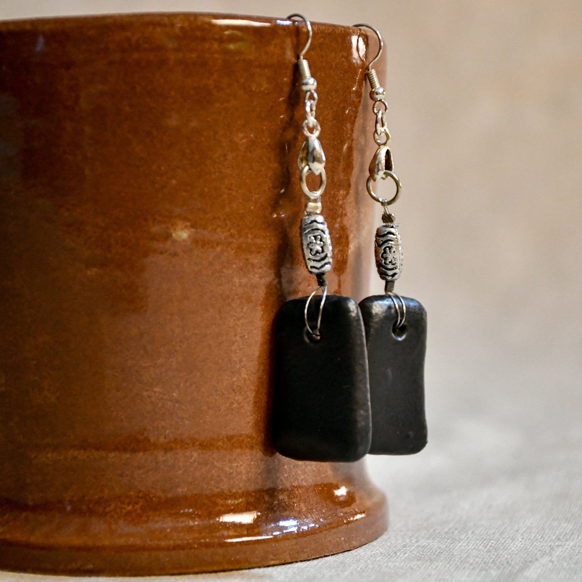 Handmade ceramic dangle earrings by Leigh Art with a modern boho silhouette.