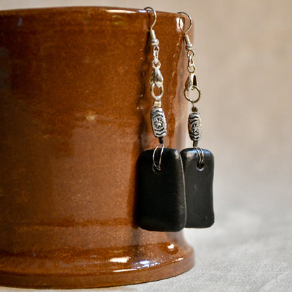 Handmade ceramic dangle earrings by Leigh Art with a modern boho silhouette.