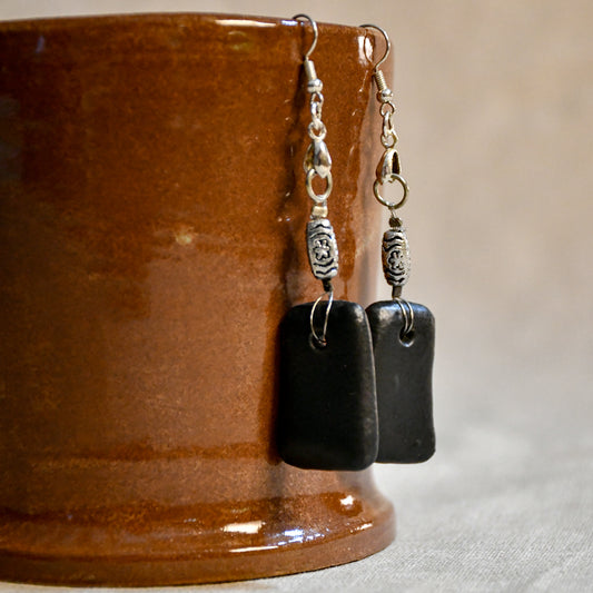 Handmade ceramic dangle earrings by Leigh Art with a modern boho silhouette.