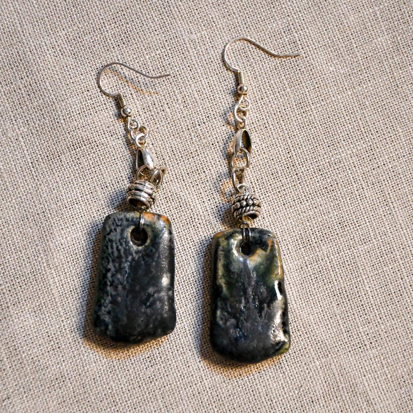 Handmade ceramic dangle earrings by Leigh Art with a modern boho silhouette.