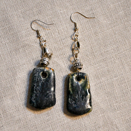 Handmade ceramic dangle earrings by Leigh Art with a modern boho silhouette.