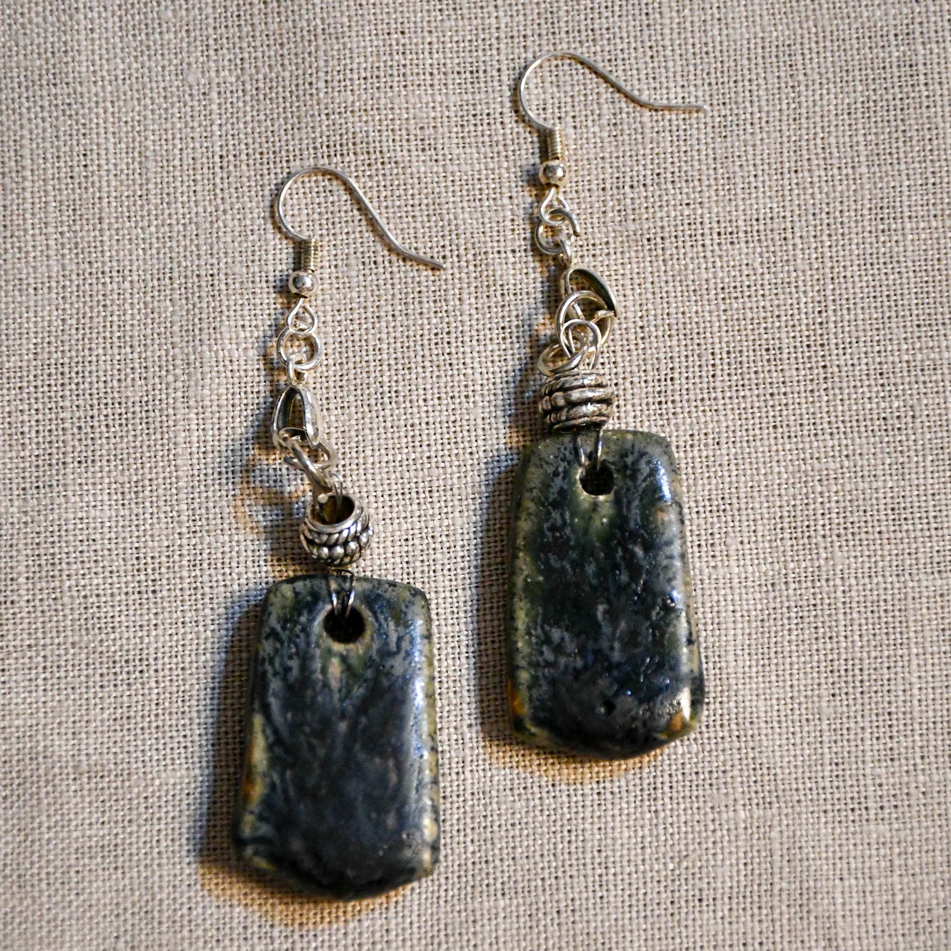 Handmade ceramic dangle earrings by Leigh Art with a modern boho silhouette.