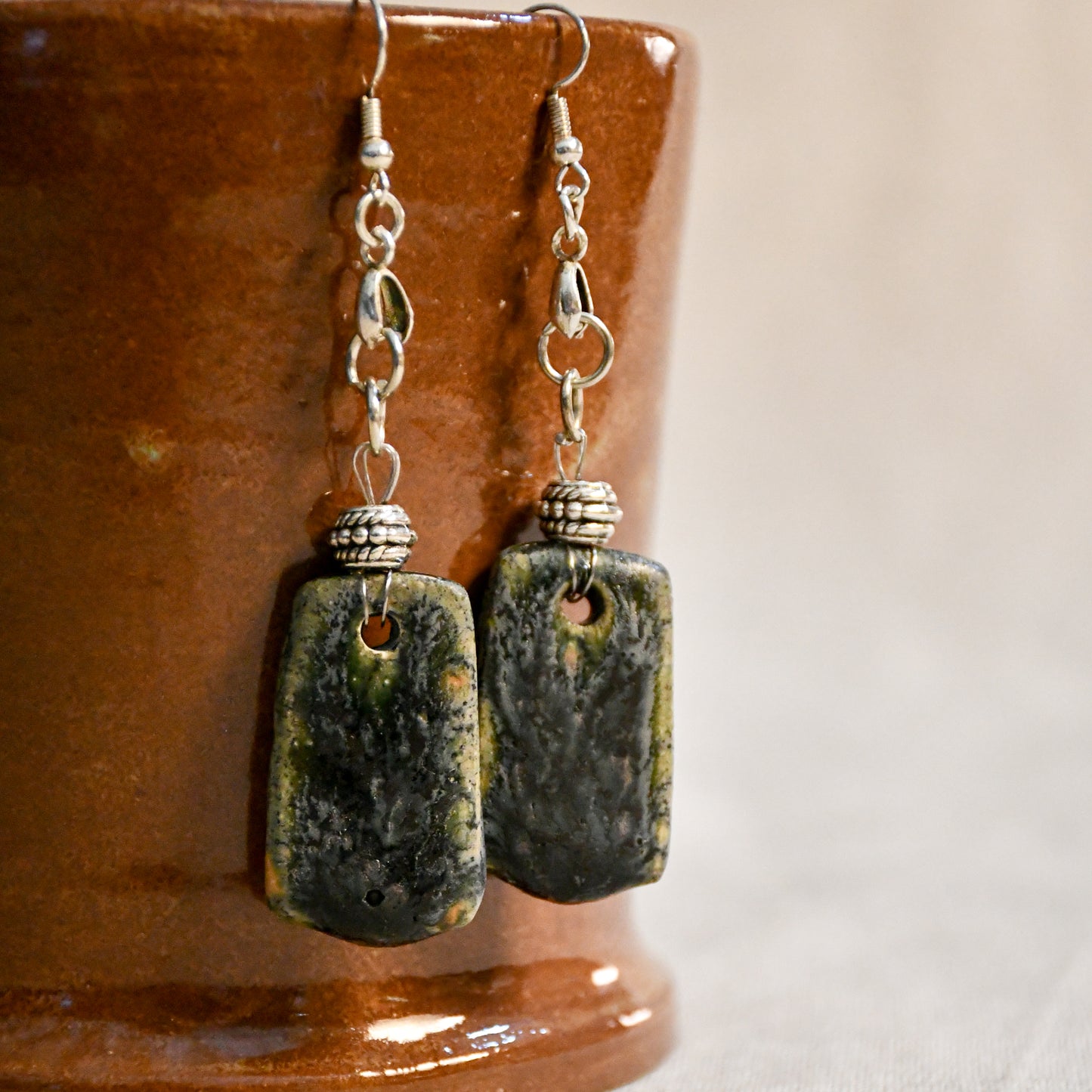 Handmade ceramic dangle earrings by Leigh Art with a modern boho silhouette.