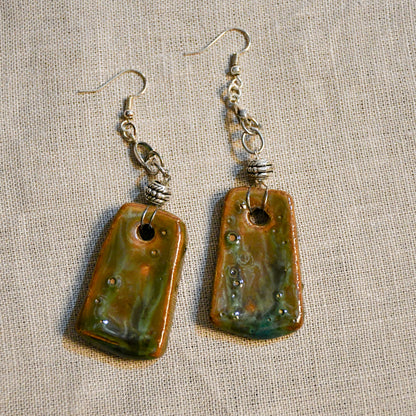 Handmade ceramic dangle earrings by Leigh Art with a modern boho silhouette.