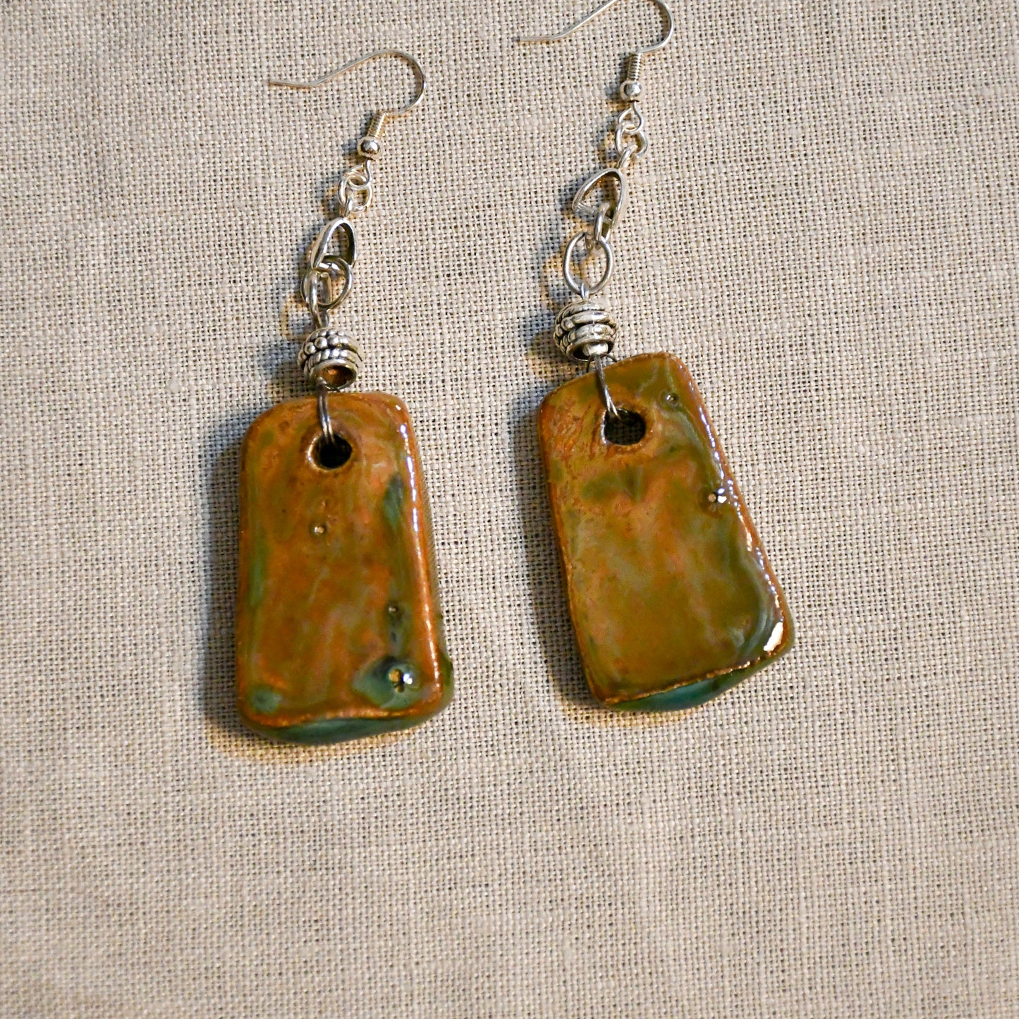 Handmade ceramic dangle earrings by Leigh Art with a modern boho silhouette.