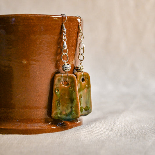 Handmade ceramic dangle earrings by Leigh Art with a modern boho silhouette.