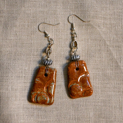Handmade ceramic stamped dangle earrings by Leigh Art.