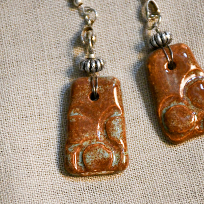 Handmade ceramic stamped dangle earrings by Leigh Art.