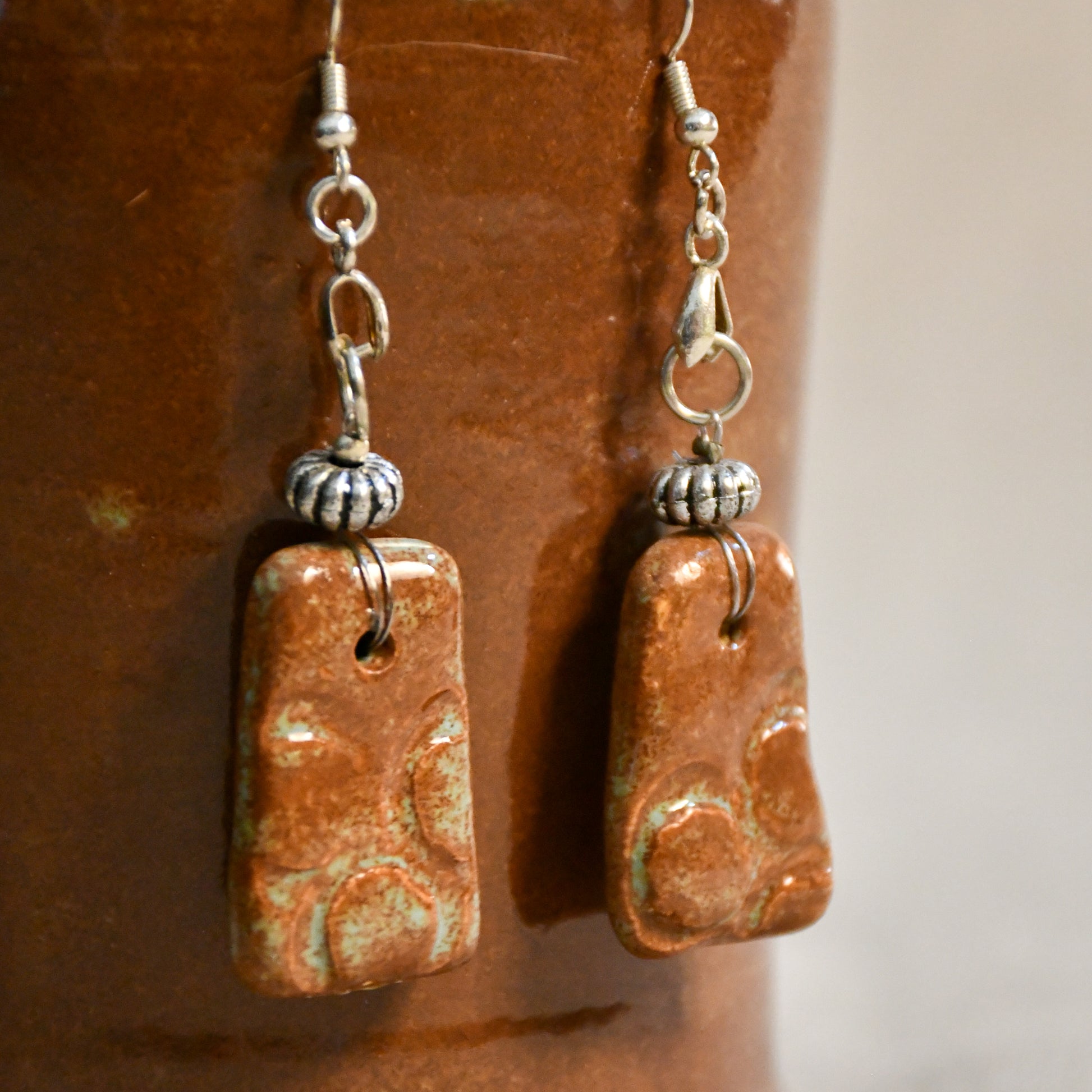 Handmade ceramic stamped dangle earrings by Leigh Art.