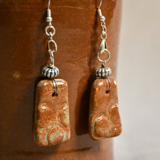 Handmade ceramic stamped dangle earrings by Leigh Art.