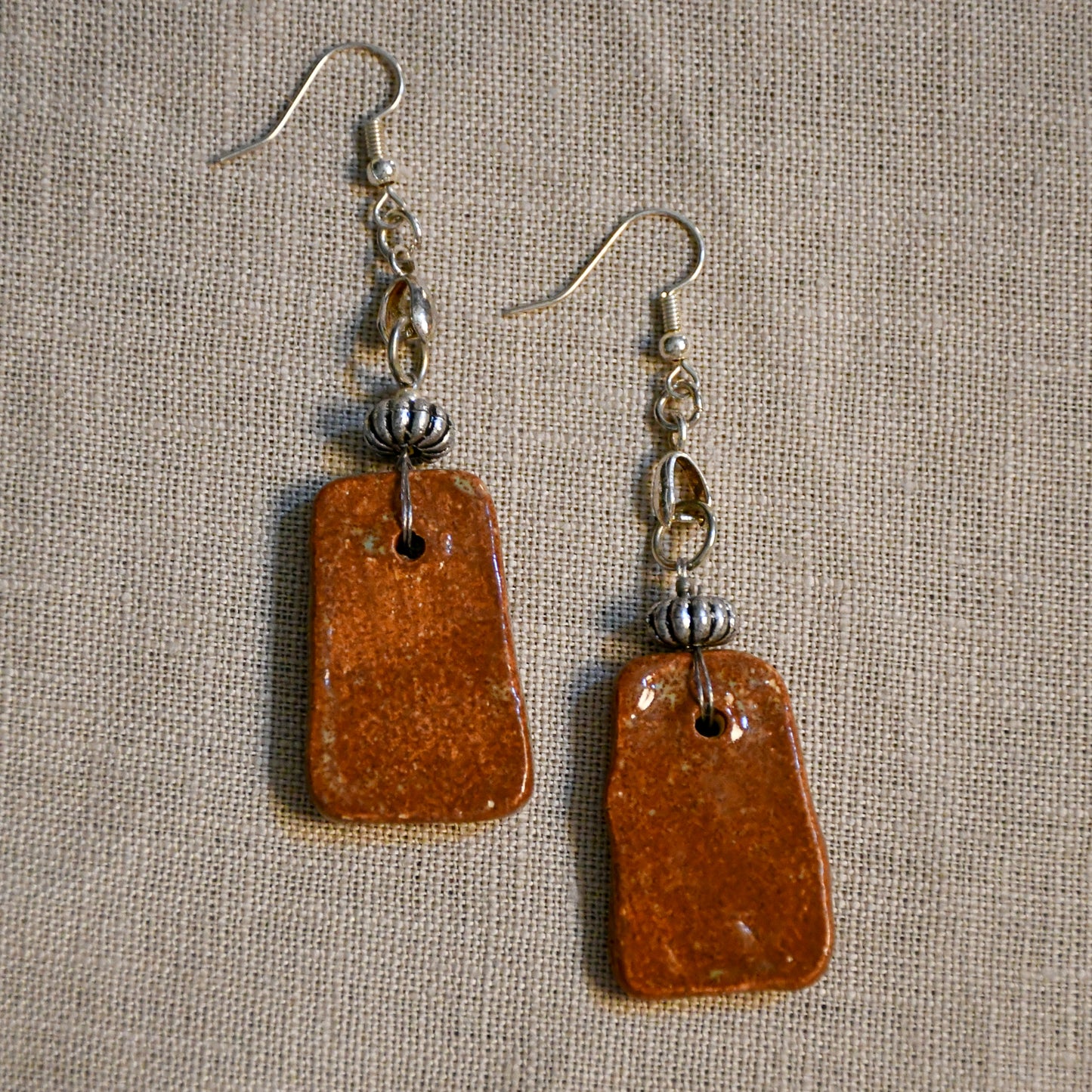 Handmade ceramic stamped dangle earrings by Leigh Art.
